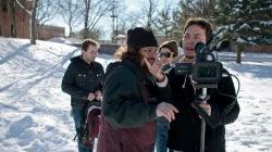 Student film crew making a movie on campus in winter